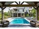 A refreshing swimming pool with sun loungers, patio seating, and a view of the home's architecture at 4121 Golf Cottage Ln, Johns Island, SC 29455