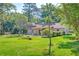 Backyard featuring a well-kept lawn, scattered trees, and partial fencing for privacy at 441 Compton Dr, Moncks Corner, SC 29461