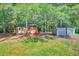 Spacious backyard featuring two outbuildings, one wood and one metal, and mature trees at 441 Compton Dr, Moncks Corner, SC 29461