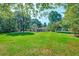 Large, manicured backyard with a view of the home and surrounding trees at 441 Compton Dr, Moncks Corner, SC 29461