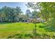 Wide shot of the backyard, displaying a well-maintained lawn and a variety of mature trees at 441 Compton Dr, Moncks Corner, SC 29461