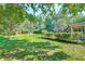 Expansive backyard with lush green grass, mature trees providing ample shade, and a shed for extra storage at 441 Compton Dr, Moncks Corner, SC 29461