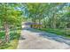 A house with a long driveway, gate, and charming exterior surrounded by mature trees at 441 Compton Dr, Moncks Corner, SC 29461