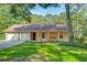 Inviting single-story home with a covered front porch and a swing, and an attached two car garage at 441 Compton Dr, Moncks Corner, SC 29461