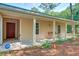 Welcoming covered front porch with a hanging swing and views of the front yard at 441 Compton Dr, Moncks Corner, SC 29461