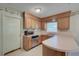 Practical kitchen features wood cabinets, stainless steel appliances, and a serving counter for casual dining at 441 Compton Dr, Moncks Corner, SC 29461