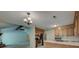View from the kitchen showing stainless appliances, wooden cabinets, and connection to the living room with fireplace at 441 Compton Dr, Moncks Corner, SC 29461