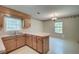 Eat-in kitchen featuring wood cabinetry, a serving counter, and a window offering natural light and views at 441 Compton Dr, Moncks Corner, SC 29461