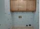 Laundry room features oak colored cabinets and quirky, fun wallpaper at 441 Compton Dr, Moncks Corner, SC 29461