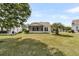 A well-maintained backyard features a lush lawn and a screened porch for outdoor enjoyment at 528 Sea Foam St, Summerville, SC 29486