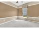Bright bedroom featuring neutral walls, plush carpet, and a window providing natural light and views at 528 Sea Foam St, Summerville, SC 29486