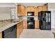 Bright kitchen featuring black appliances, tile backsplash, and light cabinetry at 528 Sea Foam St, Summerville, SC 29486