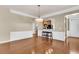 Open-concept living room with hardwood floors, view of kitchen, and elegant trim details at 528 Sea Foam St, Summerville, SC 29486