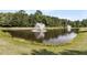 Scenic view of a tranquil pond with a central fountain, surrounded by lush green vegetation at 528 Sea Foam St, Summerville, SC 29486