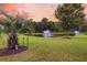 Picturesque pond view with fountains, surrounded by greenery and palm trees, creating a serene ambiance at 528 Sea Foam St, Summerville, SC 29486