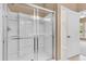 Bathroom featuring a glass shower with neutral tile, shelving, and natural light at 528 Sea Foam St, Summerville, SC 29486