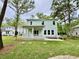 Well-maintained backyard featuring a covered porch and lush green lawn, perfect for outdoor enjoyment at 5702 Barbary Coast Rd, Hollywood, SC 29449