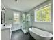Beautiful bathroom with a freestanding tub, glass shower, black hexagon tile, and great natural lighting at 5702 Barbary Coast Rd, Hollywood, SC 29449