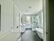 Elegant bathroom featuring a soaking tub, a glass-enclosed shower, white cabinetry, and hexagon tile flooring at 5702 Barbary Coast Rd, Hollywood, SC 29449