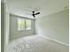 Bright bedroom with a ceiling fan and large windows offering outdoor views at 5702 Barbary Coast Rd, Hollywood, SC 29449