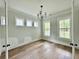 Bright bedroom with wood floors, recessed lighting, and large windows overlooking the front yard at 5702 Barbary Coast Rd, Hollywood, SC 29449