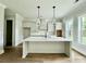 Modern kitchen with a large island, white cabinets, and pendant lighting, perfect for entertaining at 5702 Barbary Coast Rd, Hollywood, SC 29449
