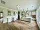 Spacious kitchen featuring a large island, white cabinets, and modern appliances with wood floors at 5702 Barbary Coast Rd, Hollywood, SC 29449