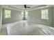 Spacious main bedroom featuring tray ceilings, a ceiling fan, and plenty of natural light from the multiple windows at 5702 Barbary Coast Rd, Hollywood, SC 29449
