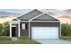 Charming single-story home featuring gray siding, white trim and a spacious two-car garage at 718 Long Bluff Rd, Summerville, SC 29486