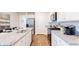 Well-lit kitchen featuring granite countertops, stainless steel appliances, and wood-look flooring at 718 Long Bluff Rd, Summerville, SC 29486