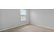 Neutral bedroom featuring carpet and walls with a window providing natural light at 807 Long Bluff Rd, Summerville, SC 29486