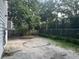 An empty backyard space with a chain link fence and a mix of concrete and gravel at 81 Rutledge Ave, Charleston, SC 29401