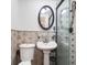 Bathroom featuring a pedestal sink, glass shower and decorative tile at 81 Rutledge Ave, Charleston, SC 29401