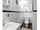 Clean bathroom featuring white tiles, dark trim, and modern fixtures at 81 Rutledge Ave, Charleston, SC 29401