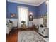 Vintage bathroom with blue walls, hardwood floors, and a decorative rug at 81 Rutledge Ave, Charleston, SC 29401
