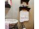 Bathroom showcasing a vessel sink with iron details, and decorative shelves with towels at 81 Rutledge Ave, Charleston, SC 29401
