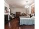 Charming bedroom with hardwood floors, a decorative fireplace, and bright chandelier at 81 Rutledge Ave, Charleston, SC 29401