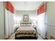 Relaxing bedroom featuring a floral-patterned quilt, matching curtains, and soft lighting at 81 Rutledge Ave, Charleston, SC 29401