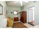 Airy bedroom featuring a vintage wardrobe, floral armchairs and access to another room at 81 Rutledge Ave, Charleston, SC 29401