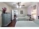 Bedroom with twin beds, hardwood floors, and a gray dresser, offering cozy appeal at 81 Rutledge Ave, Charleston, SC 29401