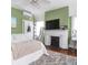 Spacious bedroom with fireplace, modern decor, and large windows, perfect for relaxation at 81 Rutledge Ave, Charleston, SC 29401
