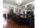 Elegant dining room featuring a chandelier, dark wood table and chairs, and decorative accents at 81 Rutledge Ave, Charleston, SC 29401