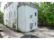 A multi-story home with white siding and a rooftop balcony, set in a quiet neighborhood at 81 Rutledge Ave, Charleston, SC 29401