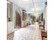 Unique hallway featuring patterned tile flooring, arched doorways, and elegant lighting fixtures at 81 Rutledge Ave, Charleston, SC 29401