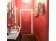 Vibrant red hallway with decorative mirrors and display table offers an inviting ambiance at 81 Rutledge Ave, Charleston, SC 29401