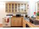 Cozy kitchen featuring wooden cabinets with glass doors, a white range, and essential appliances at 81 Rutledge Ave, Charleston, SC 29401