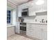 Bright kitchen with white cabinets, stainless appliances, and ample counter space at 81 Rutledge Ave, Charleston, SC 29401