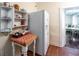 Bright kitchen area with white refrigerator, open shelving, and view into an adjacent room at 81 Rutledge Ave, Charleston, SC 29401