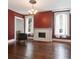 Spacious living room featuring a decorative fireplace, large windows, and a stylish chandelier at 81 Rutledge Ave, Charleston, SC 29401