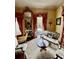 Cozy living room featuring a marble table, ornate mirror, elegant seating and red patterned curtains at 81 Rutledge Ave, Charleston, SC 29401